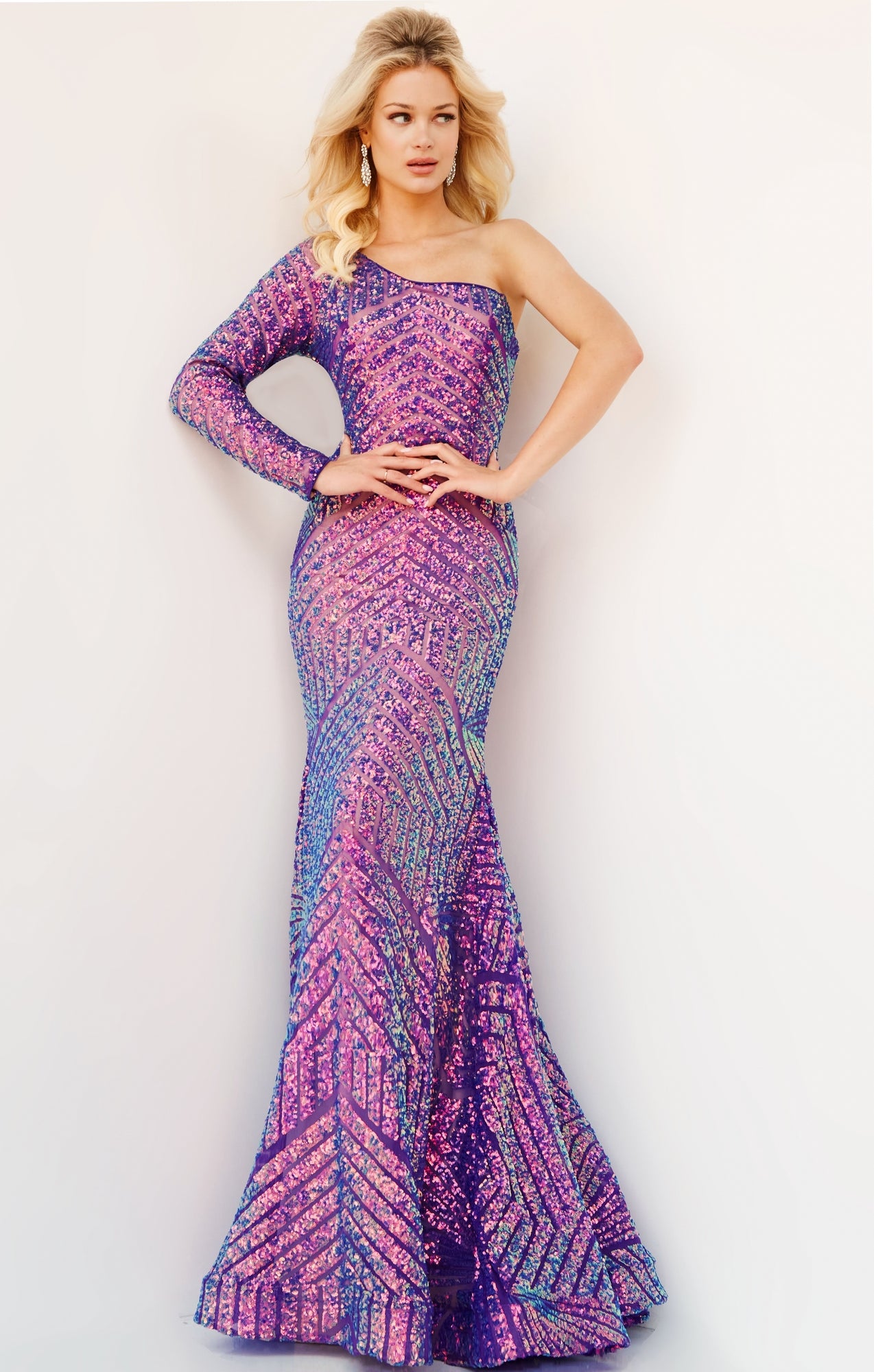 A woman poses in a fitted, floor-length Jovani Violet Purple Prom Dress featuring one long sleeve and striking geometric sequin patterns.